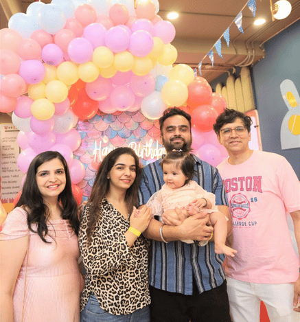 Family enjoying a child's birthday celebration at Mio Wooray with colourful balloons and a fairy-themed backdrop.