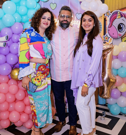 Family celebrating a child's birthday at Mio Wooray with colourful balloon decorations and a unicorn-themed backdrop.