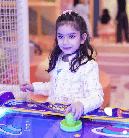 Girl playing an interactive arcade game at Mio Wooray indoor play area.