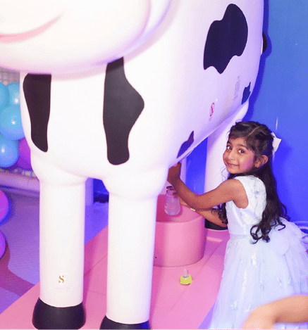 Child enjoying a cow-themed play activity at Mio Wooray indoor play area.
