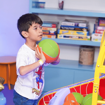 Child enjoying a ball game at Mio Wooray indoor play area.