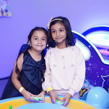 Two children enjoying an interactive indoor play activity at Mio Wooray.