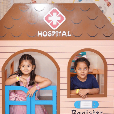 Two children enjoying a hands-on creative play activity at Mio Wooray.