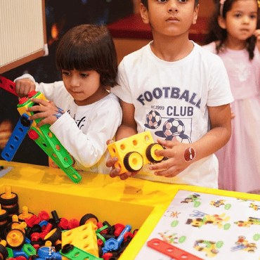 Child enjoying an interactive arcade game at Mio Wooray indoor play area.
